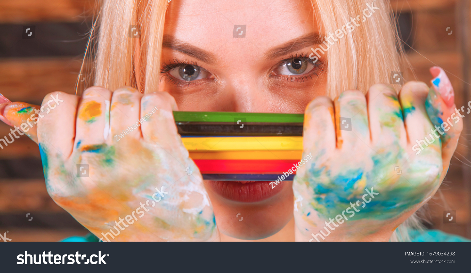 stock-photo-humorous-photo-of-great-artist-portrait-of-beautiful-young-woman-painting-with-colored-pencils-1679034298